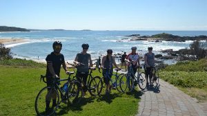 Coffs Coast Cycling Tours - Group of cyclists enjoying a scenic beach cycle tour.